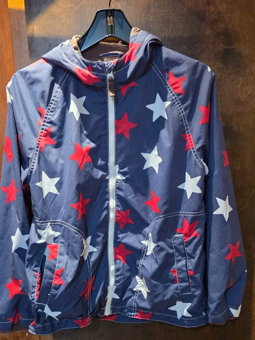 rain jacket features a navy blue background covered in a bold red and white star